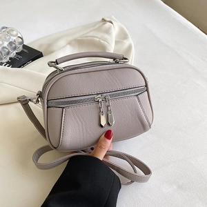 Mauve lychee grain leather crossbody bag with double zippers and top handle