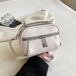 Chic beige lychee grain faux leather crossbody bag with triple zipper compartments