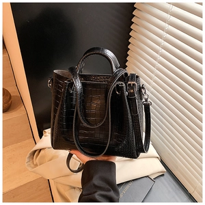 Chic black crocodile pattern bucket bag with handles and adjustable shoulder strap