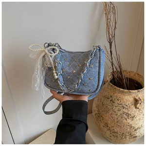 Light blue denim handbag with silver studs, pearl bow detail and lace ribbons