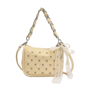 Beige quilted handbag with rhinestones, metal chain strap and white lace bow accessory