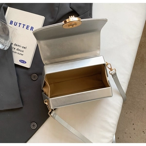 Interior view of silver glossy crossbody bag with khaki lining and gold twist lock