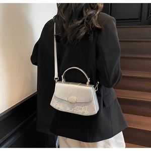 Silver snakeskin texture patchwork bag with gold hardware and smooth leather flap detail