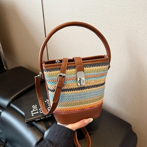 Colorful woven bucket bag with striped pattern and brown leather straps for women