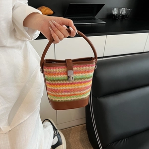 Rainbow striped woven bucket bag with leather handles and metallic buckle closure