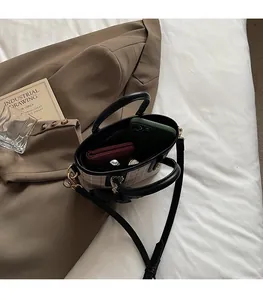 Top-down view of checkered handbag interior showing space for phone and wallet