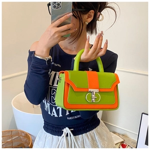 Detail of vintage square handbag with green and orange leather and silver ring buckle