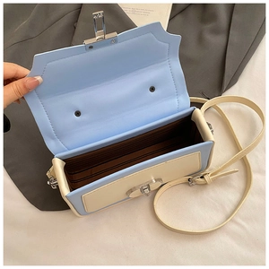 Detail view of the bag's internal multi-compartment bellows structure and silver lock