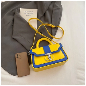 Detail of yellow and royal blue leather crossbody bag with silver double-ring buckle