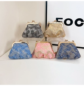 Close-up of vintage floral jacquard fabric bags with metallic kiss-lock and chain