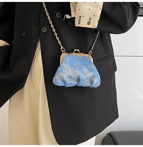 Blue and silver sparkling mini crossbody bag with gold chain and clasp on model