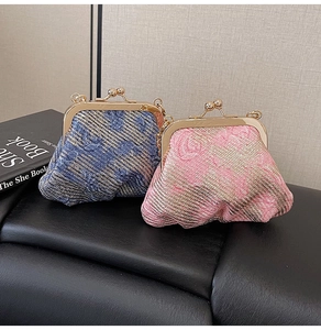 Detail of vintage mini coin purses with pleated fabric texture and gold metal clasps