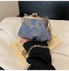 Detailed view of luxury jacquard fabric and gold clasp on vintage evening bag