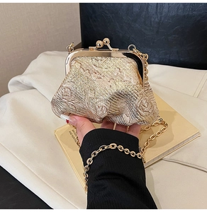 Close-up of golden woven texture and vintage metal clasp on a stylish evening bag