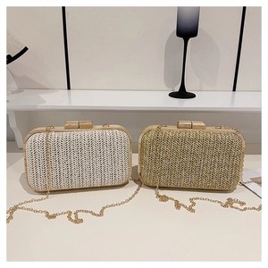 Detail of woven straw crossbody bags with wooden frames and fine metal chain straps