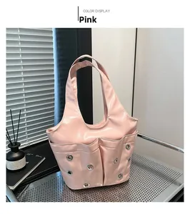 Pink glossy patent leather shoulder bag featuring metal grommets and trendy pocket details