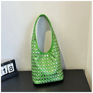 Detailed view of the neon green underarm bag with shiny silver stud embellishments