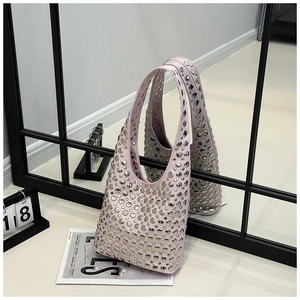 Detail of light pink hobo bag featuring dense silver stud rivets and a sleek leather finish