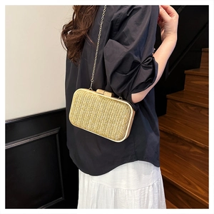 Detail showing handwoven texture and wooden clasps of the champagne gold crossbody bag
