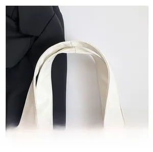 Detailed close-up of premium white leather shoulder strap with durable double stitching
