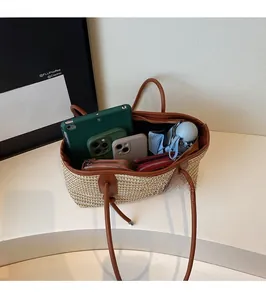 Interior view showing straw tote capacity for tablet, phone, and daily essentials
