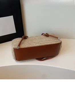 Detail of the natural straw crossbody bag featuring premium brown leather base and knot strap