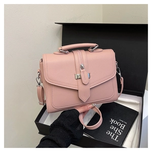 Detailed macro view of pink litchi grain handbag with silver hardware in gift box