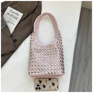Close-up of pink rivet hobo bag with silver metallic studs and soft leather texture