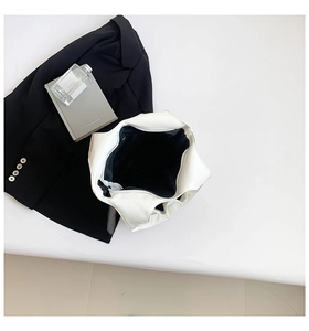 Top view of white minimalist handbag with matte leather texture on aesthetic background