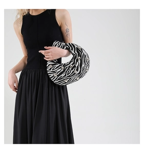 Detail showing the zebra pattern fabric with silver ball studs and knotted handle detail