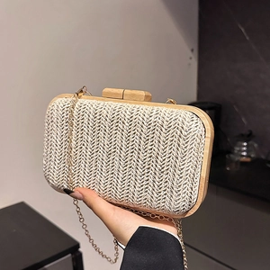 Handheld woven straw handbag in beige chevron pattern with wooden frame and gold chain