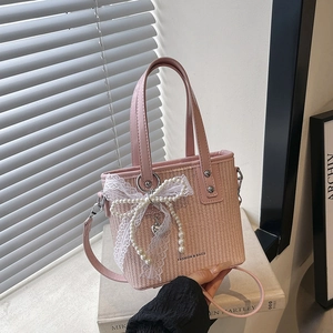 Pink woven handbag with white lace bow, pearl charm and heart pendant for women
