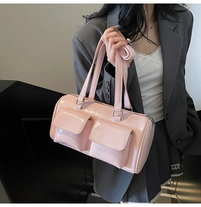 Pink patent leather underarm bag featuring dual front pockets and silver hardware detail