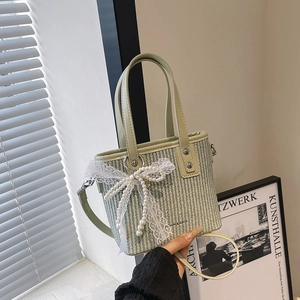 Mint green woven handbag with white lace bow and pearl charms for summer style