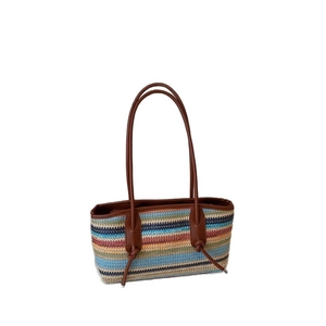 Minimalist colorful striped woven shoulder bag with brown leather handles and knot details