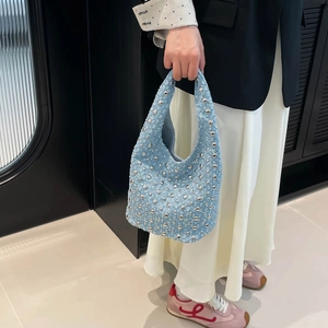 Chic blue denim hobo bag with silver studs and Y2K moon shape aesthetic for women