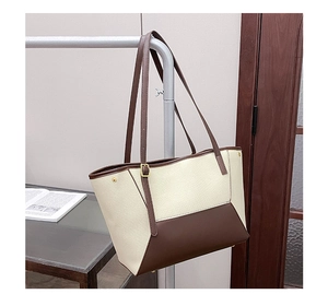 Détails du sac cabas bicolore avec rivets de protection dorés et bandoulière réglable