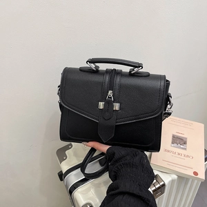 Structured black lychee textured handbag with vertical zipper and top handle design