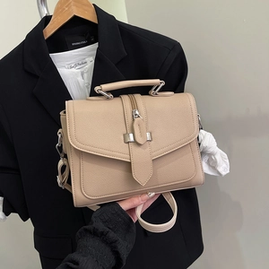 Minimalist beige litchi pattern handbag with top handle and adjustable shoulder strap