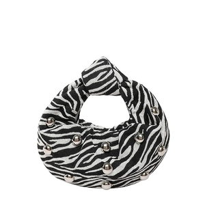 Zebra print underarm bag with silver studs and knot strap design on white background
