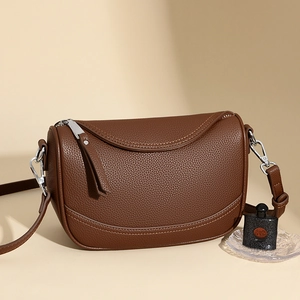 Brown lychee leather crescent shoulder bag with silver hardware and soft curve flap