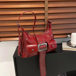 Red patent leather motorcycle bag with multi-pocket design and metallic buckle accents