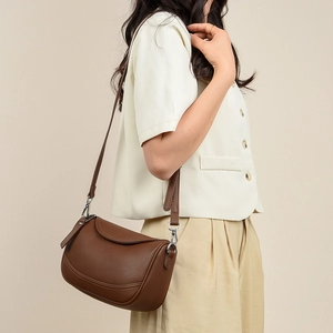 Detailed view of brown lychee grain leather shoulder bag with adjustable strap and silver metal