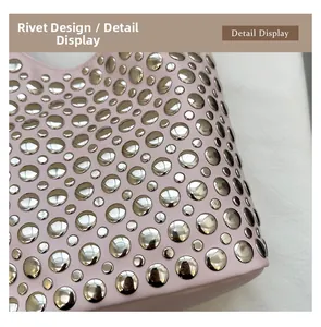 Detail display of pink leather bag featuring decorative silver metal stud accents