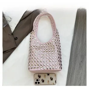 Pink rivet bucket bag detail showing dimensions compared with a mobile phone