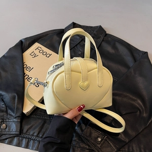 Pale yellow heart-shaped PU leather handbag with embossed pattern and detachable strap