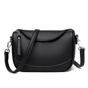 Minimalist black pebble leather half-moon shoulder bag with silver hardware and strap