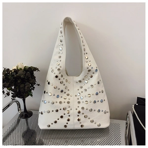 Detail shot of the large white hobo bag showing stylish silver metal rivet patterns