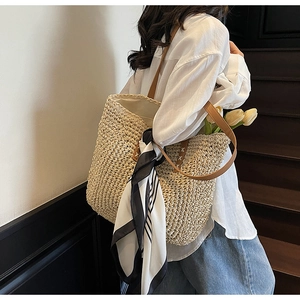 Detail of large straw tote bag with black and white striped scarf and tulip accents