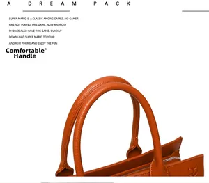Detail of comfortable dual handles and silver zipper on orange-brown lychee leather tote